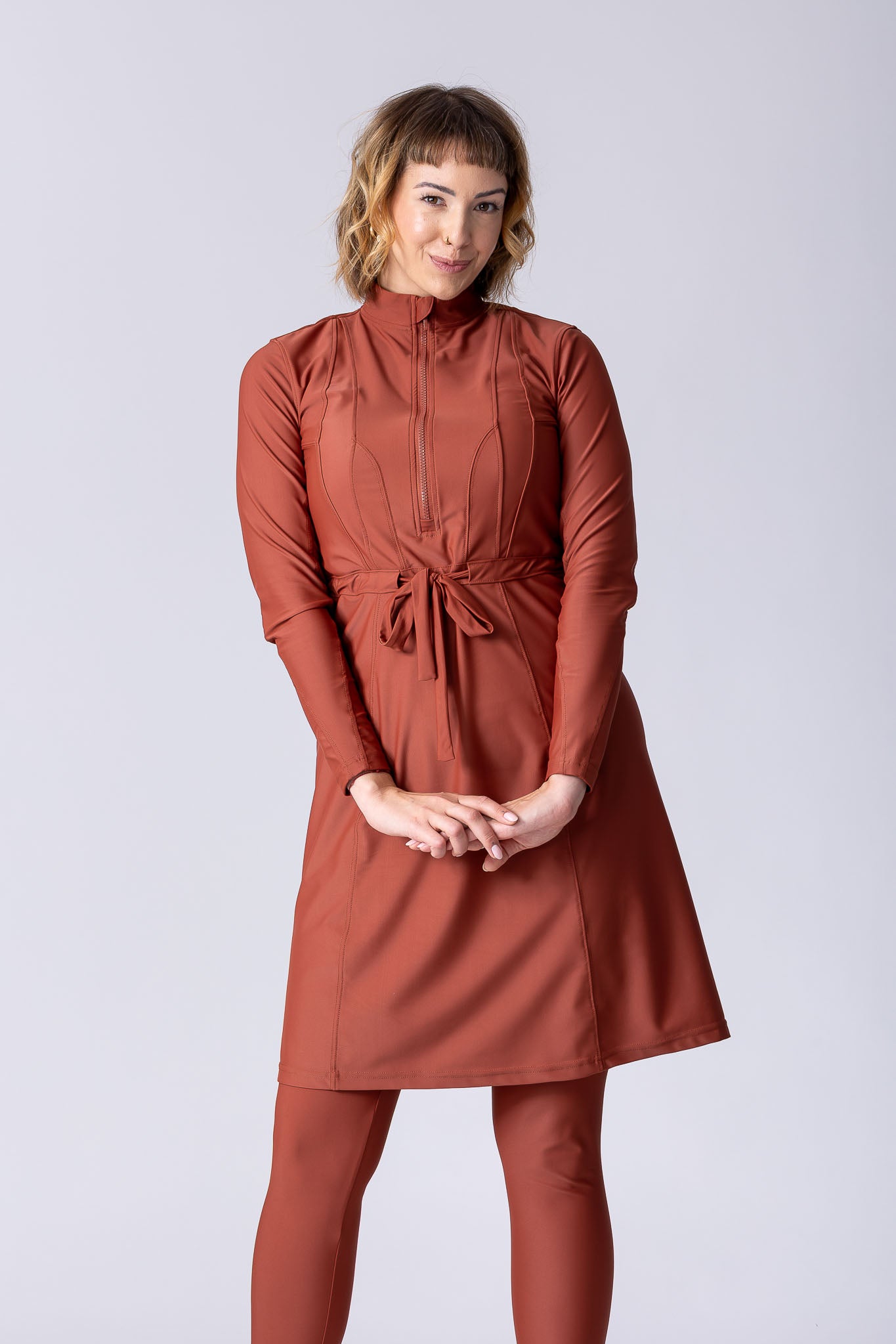 Modest midi swim tunic in terracotta with front zipper, waist belt and UV proof swim fabric.