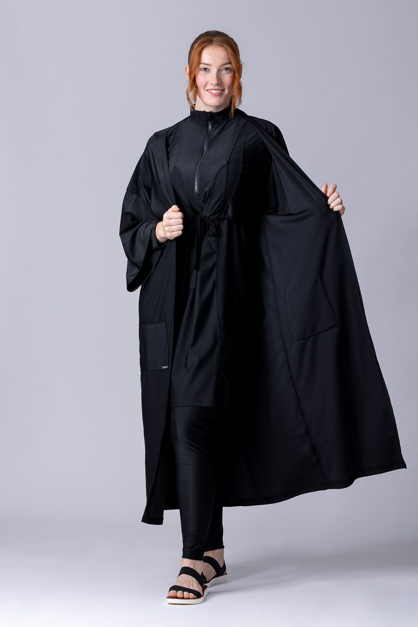 Beach Cover Up in black maxi length with pocket, belt and made of swim fabric.