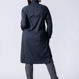 Long line tunic top in black. With front zipper, hidden side panels, back breathability panel and waist belt with buckle.