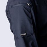Long line tunic top in black. With front zipper, hidden side panels, back breathability panel and waist belt with buckle.