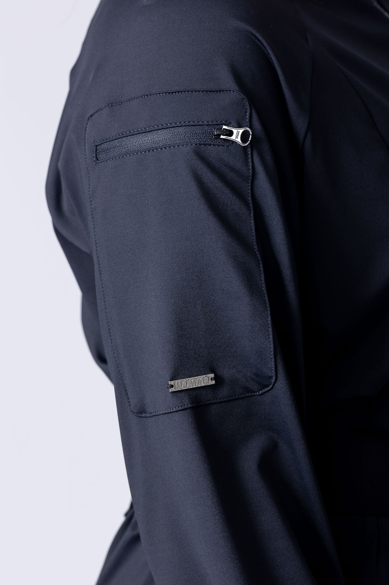 Long line tunic top in black. With front zipper, hidden side panels, back breathability panel and waist belt with buckle.