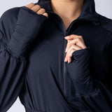 Long line tunic top in black. With front zipper, hidden side panels, back breathability panel and waist belt with buckle.