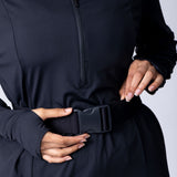 Long line tunic top in black. With front zipper, hidden side panels, back breathability panel and waist belt with buckle.