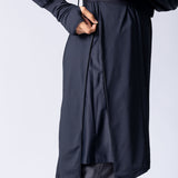 Long line tunic top in black. With front zipper, hidden side panels, back breathability panel and waist belt with buckle.