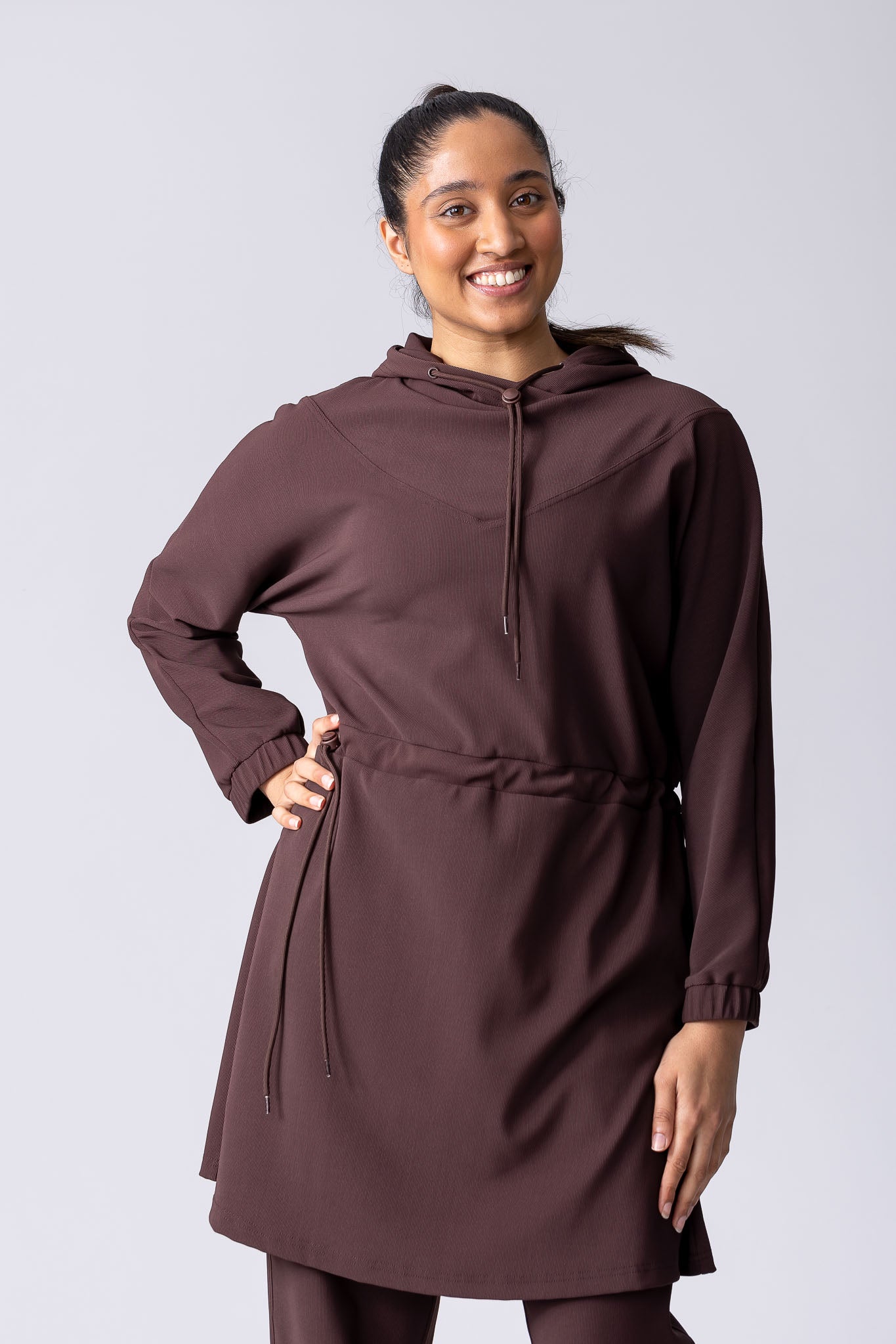 Coffee or brown colour longline hoodie with waist adjustability and draw string.