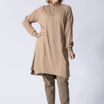 Long line tunic top in beige. With front zipper, hidden side panels, back breathability panel and waist belt with buckle.