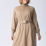 Long line tunic top in beige. With front zipper, hidden side panels, back breathability panel and waist belt with buckle.