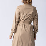 Long line tunic top in beige. With front zipper, hidden side panels, back breathability panel and waist belt with buckle.