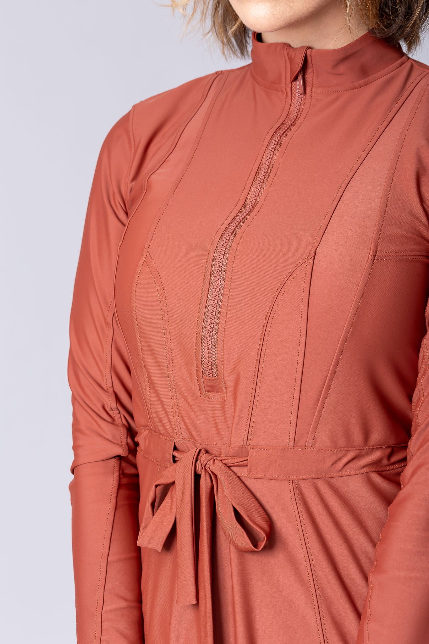 Modest midi swim tunic in terracotta with front zipper, waist belt and UV proof swim fabric.