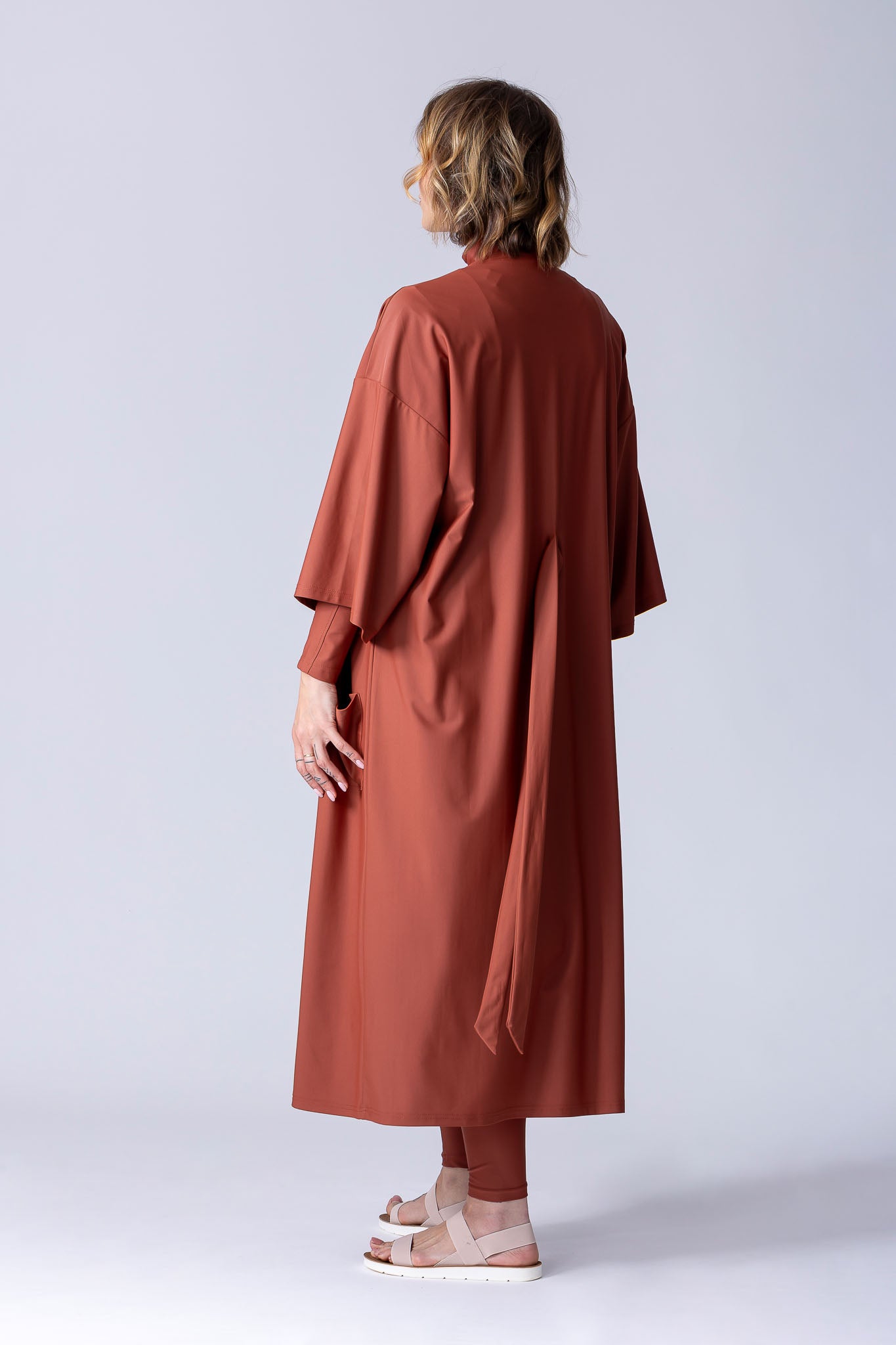 Beach Cover Up in terracotta colour maxi length with pocket, belt and made of swim fabric.