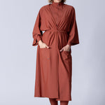Beach Cover Up in terracotta colour maxi length with pocket, belt and made of swim fabric.