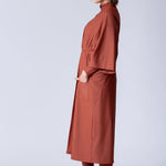 Beach Cover Up in terracotta colour maxi length with pocket, belt and made of swim fabric.