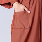 Beach Cover Up in terracotta colour maxi length with pocket, belt and made of swim fabric.