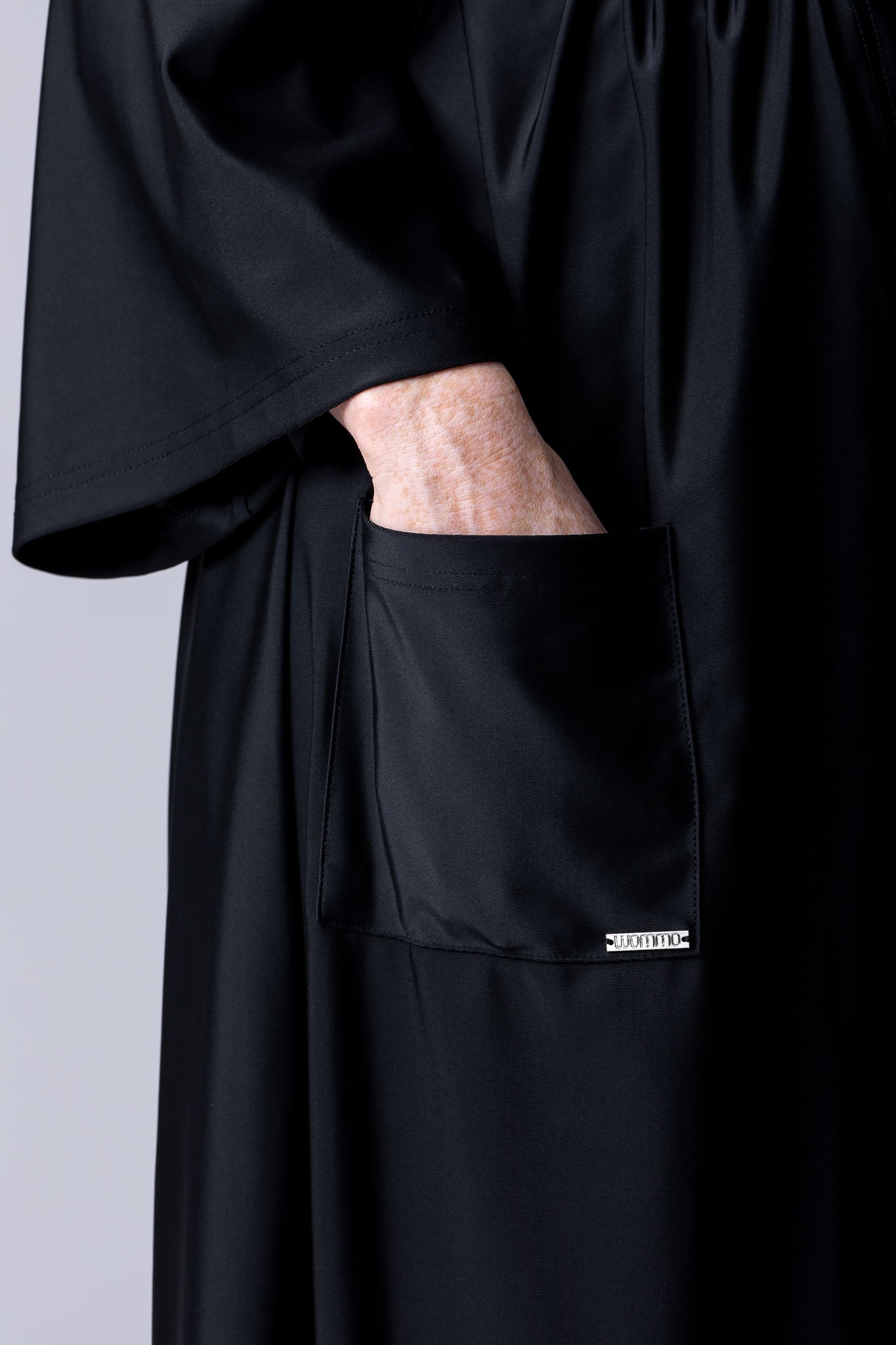 Beach Cover Up in black maxi length with pocket, belt and made of swim fabric.