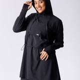 Light weight long line hoodie in black with adjustable waist, front pocket and large hood.