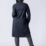 Long line tunic top in black. With front zipper, hidden side panels, back breathability panel and waist belt with buckle.