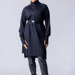 Long line tunic top in black. With front zipper, hidden side panels, back breathability panel and waist belt with buckle.