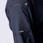 Long line tunic top in black. With front zipper, hidden side panels, back breathability panel and waist belt with buckle.