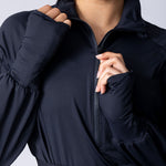 Long line tunic top in black. With front zipper, hidden side panels, back breathability panel and waist belt with buckle.