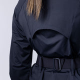 Long line tunic top in black. With front zipper, hidden side panels, back breathability panel and waist belt with buckle.
