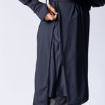Long line tunic top in black. With front zipper, hidden side panels, back breathability panel and waist belt with buckle.